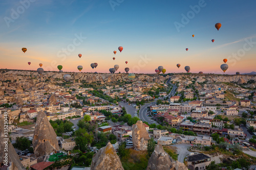 Hot Air balloons flying over amazing rock forms in Cappadocia