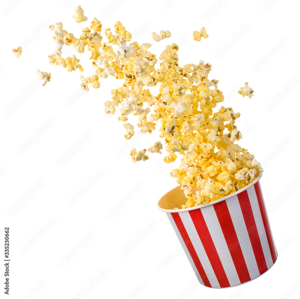 Flying popcorn from paper striped bucket isolated on black background Flying popcorn from paper striped bucket isolated on black background