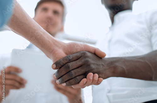 in the foreground handshake business partners
