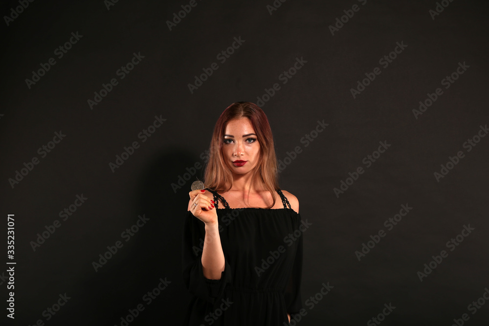 Obraz premium Beautiful woman holding and throwing the silver coin