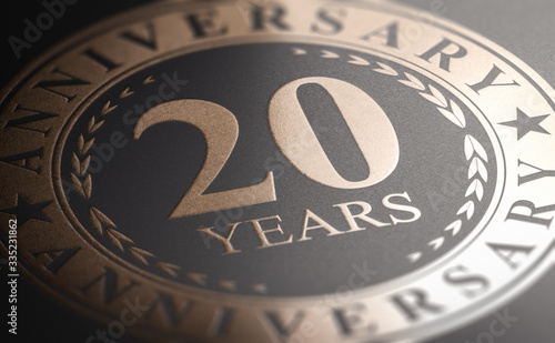 20th anniversary, golden stamp over black background. Twenty years celebration card photo