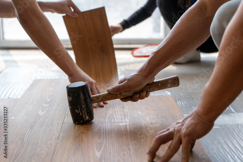 the contractor team working on installing sheet vinyl floor tile on site 