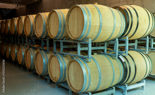 resting wooden barrels of wine in the wine cellar