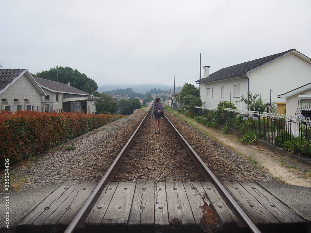Naklejka premium Pilgrim walk around single railway, Camino de Santiago, Way of St. James, Journey from Valenca to Cesantes, Portuguese way, Portugal
