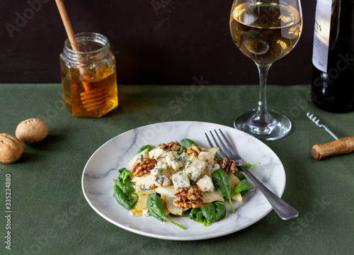 Salad with spinach, pear and blue cheese. Healthy eating. Vegan food. Diet. Recipe. photo