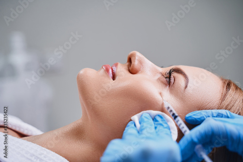 Calm pretty female during mesotherapy stock photo photo