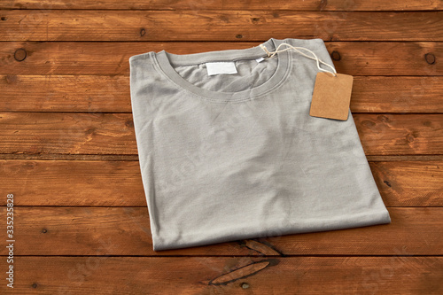 Gray t-shirt on wooden background