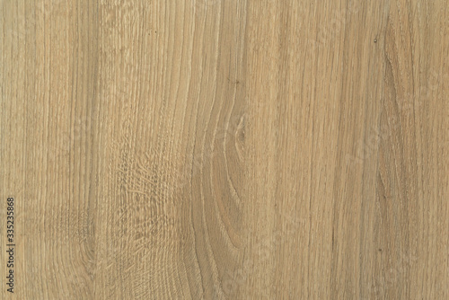 Photographed texture of wood with wood grain in the middle in a yellow brown color