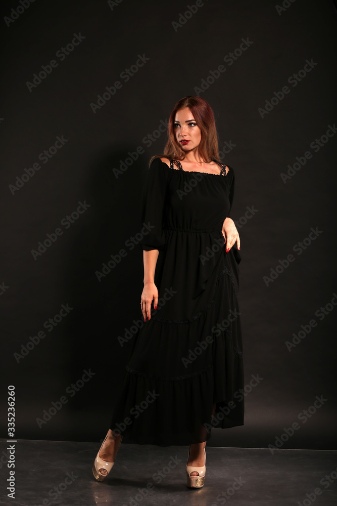 Studio portrait of pretty woman in black dress on dark background Studio portrait of pretty woman in black dress on dark background