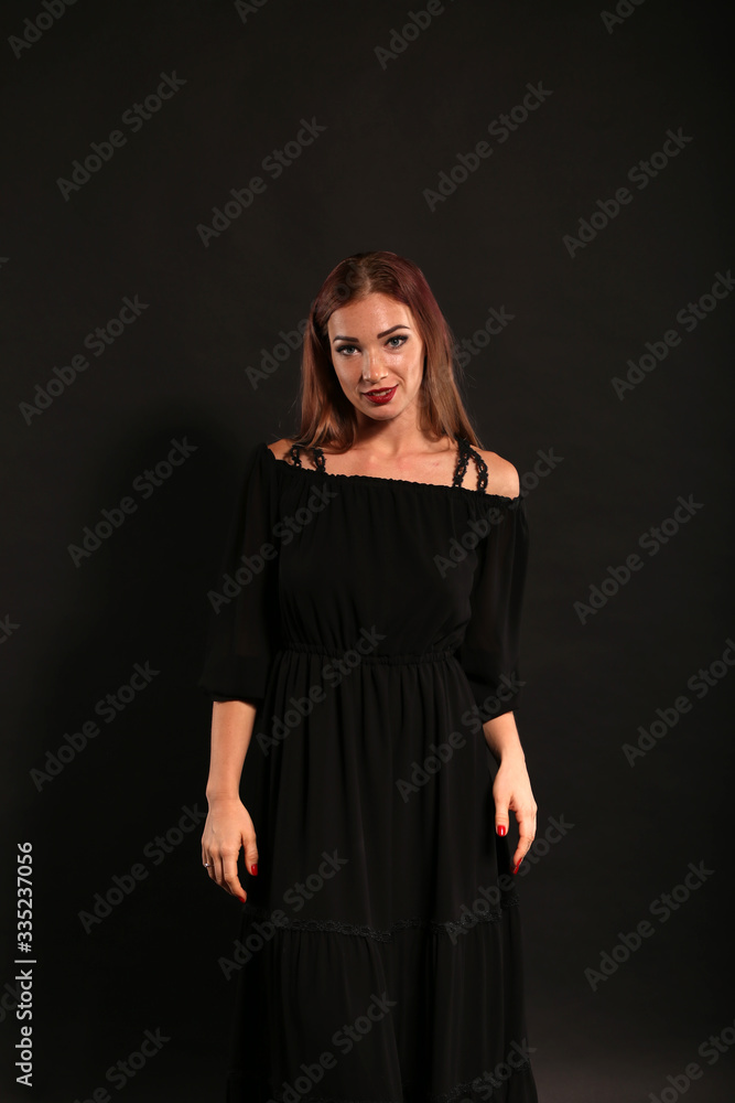 Studio portrait of pretty woman in black dress on dark background Studio portrait of pretty woman in black dress on dark background