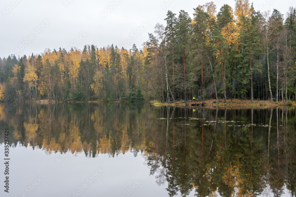 Fototapeta premium Calm lake and forest in fall colors, Finland