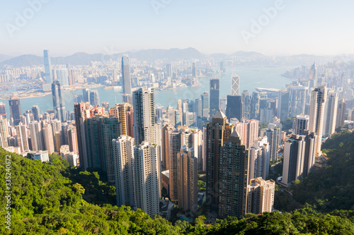 Hong Kong's beautiful skyline. The Peak Tower deck view (The Peak) on a sunny day, Hong Kong, China. Hong Kong Island and Kowloon's skyscrapers & South China Sea. Near Victoria Peak. © Julien