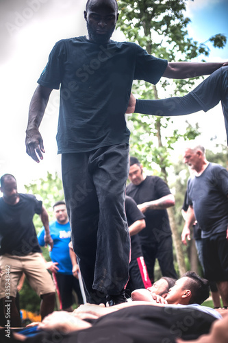 Civilian people trample over crowd lie on ground. Boot camp