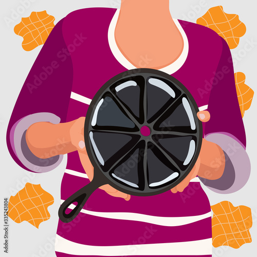Woman in pink t-shirt show in her hand waffle iron for prepared waffles isolated on light background. Stock vector cute illustration of waffle cooker in flat cartoon style.