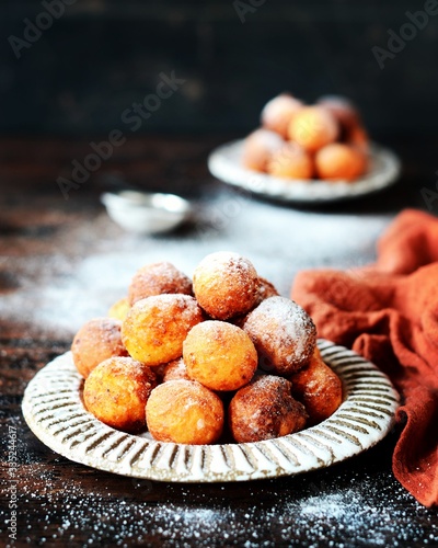 Cottage cheese donuts in a ceramic dish on a dark wooden table
