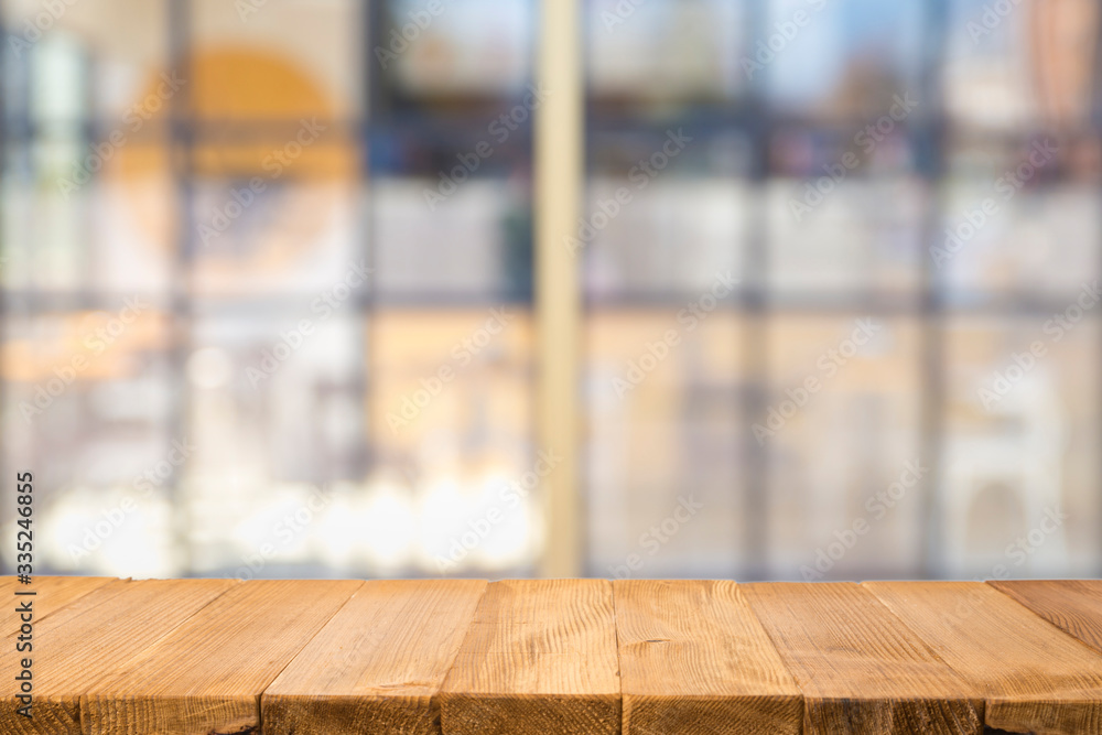 Wooden board empty table in front of blurred background. Perspective brown wood over blur in coffee shop - can be used for display or montage your products.Mock up your products.Vintage filter. Wooden board empty table in front of blurred background. Perspective brown wood over blur in coffee shop - can be used for display or montage your products.Mock up your products.Vintage filter.
