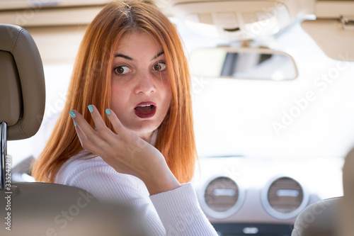 Tapeta Young woman driving a car backwards