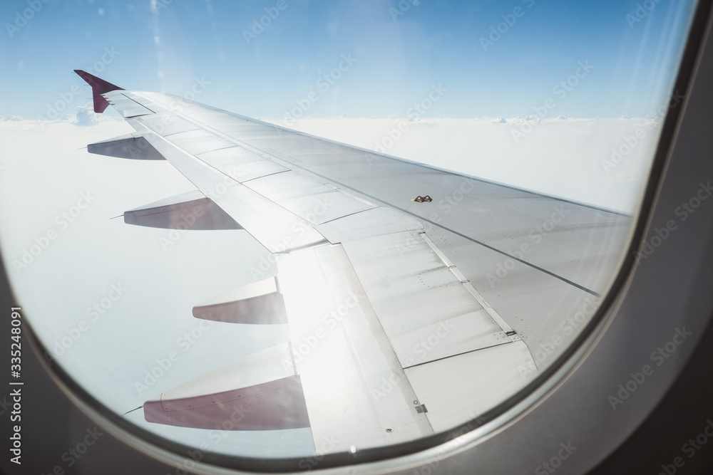 View of beautiful cloud and wing of airplane from window View of beautiful cloud and wing of airplane from window
