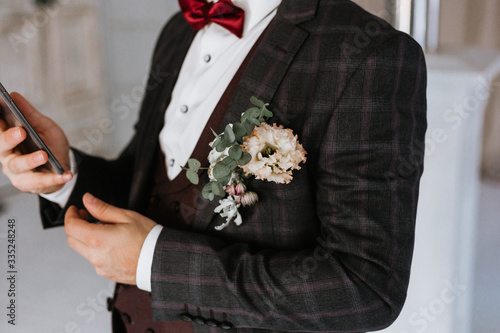 groom in a suit with flowers