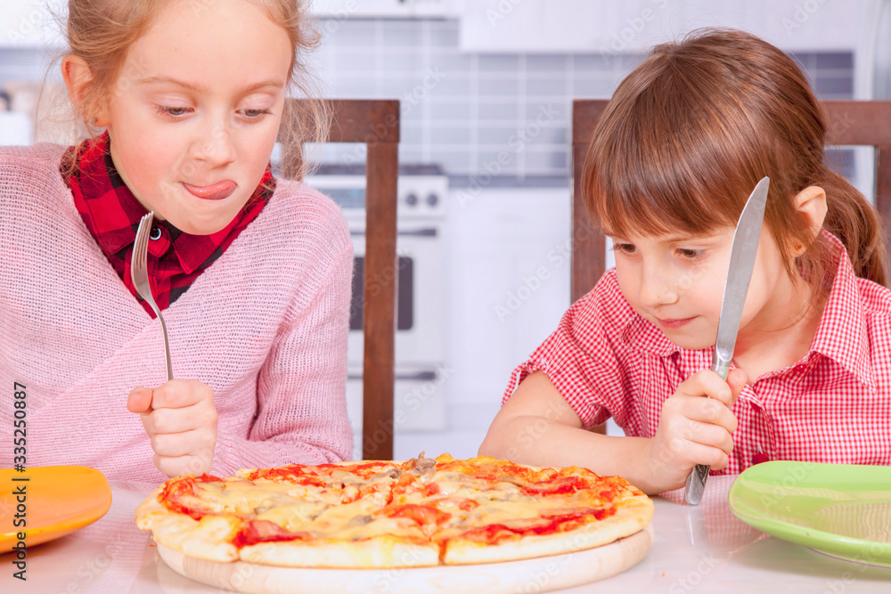 We love pizza! Cute little girls best friends eating pizza. We love pizza! Cute little girls best friends eating pizza.