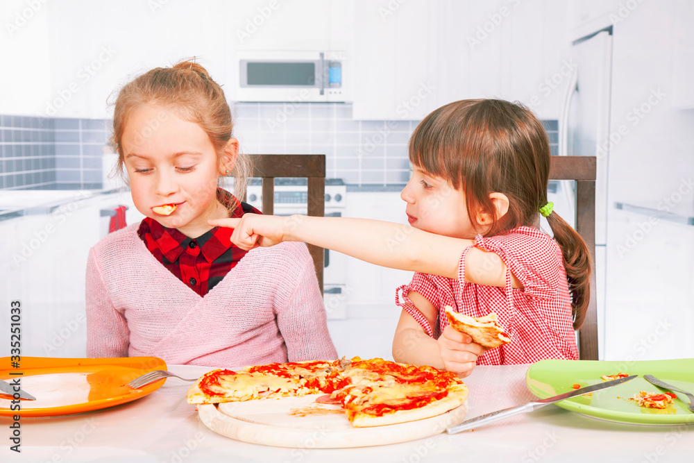 Funny image of cute little child girls eating pizza slices as symbol of best food. Horizontal image. Funny image of cute little child girls eating pizza slices as symbol of best food. Horizontal image.