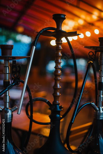 Stylish wooden hookah in the evening on a summer terrace in a cafe