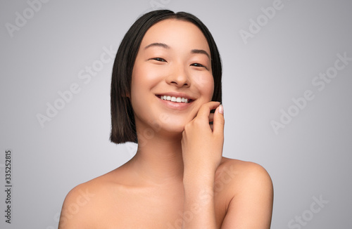 Delighted ethnic woman with clean skin