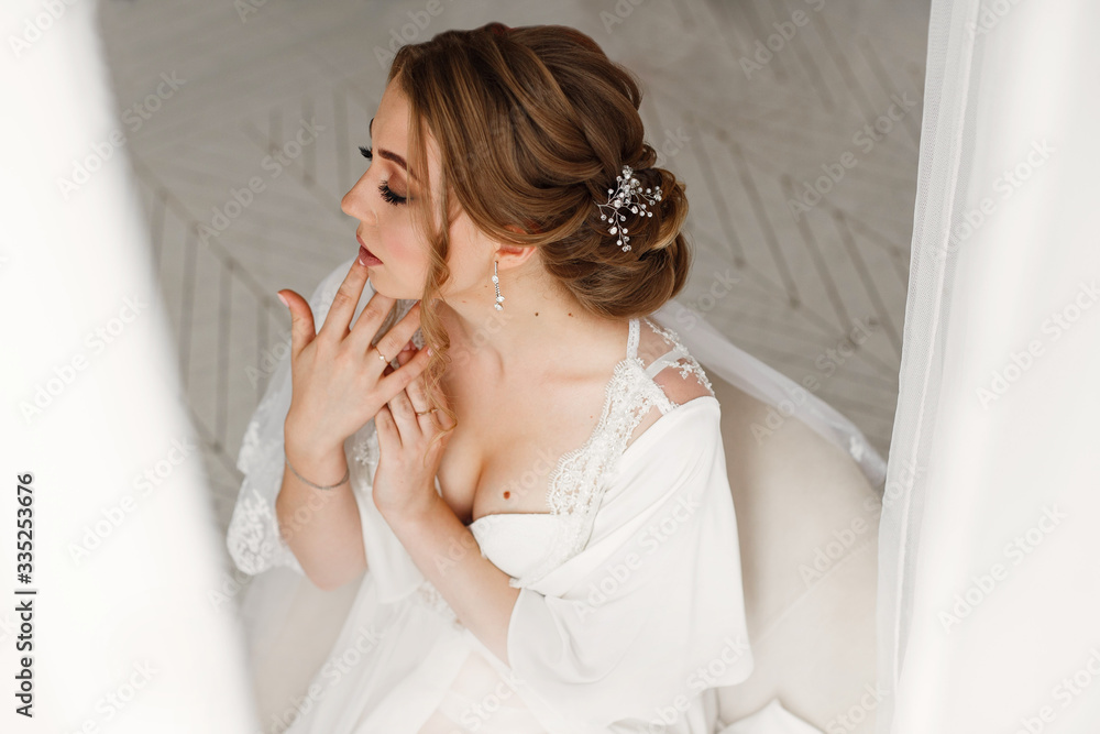 bride with beautiful neckline, make up and hairstyle in white underwear. morning of bride in hotel room close up. studio portrait of young blonde woman in white lace dress close up. wedding day bride with beautiful neckline, make up and hairstyle in white underwear. morning of bride in hotel room close up. studio portrait of young blonde woman in white lace dress close up. wedding day