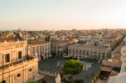 Catania, Sicily in Italy. Aerial view of the city roofs and in particoular the magnificent Duomo square at sunset, nice warm colors and soft light. Shot from the badia of Sant'Agata church photo