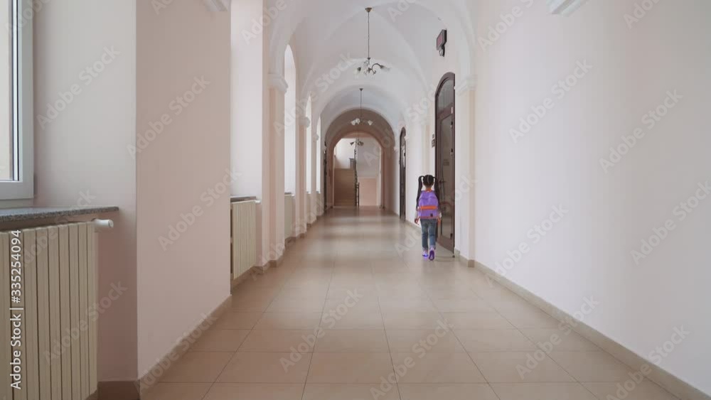 Girl with backpack entering classroom. Girl with backpack entering classroom.