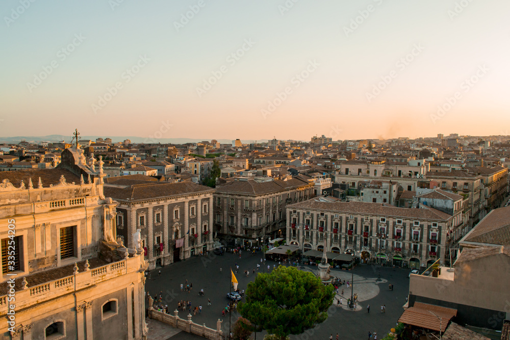 Catania, Sicily in Italy. Aerial view of the city roofs and in particoular the magnificent Duomo square at sunset, nice warm colors and soft light. Shot from the badia of Sant'Agata church