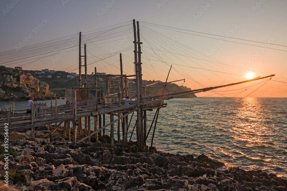 Trabucco, ancient wooden structure of the fishermen of the lower Adriatic Sea in the Gargano in Italy, in the sunset light.