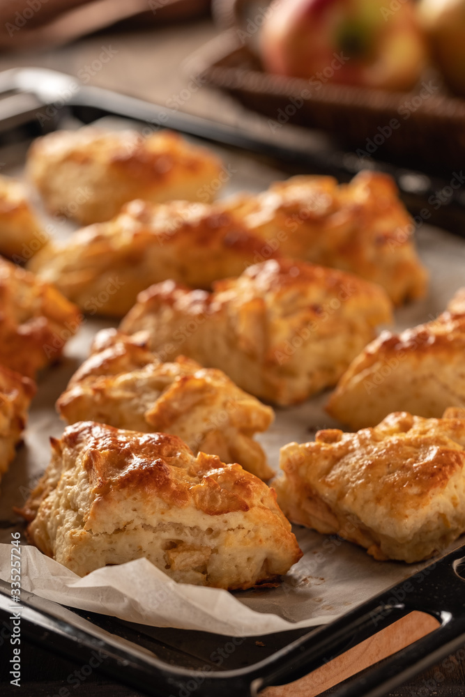 Tasty, fragrant and tender scones with apples from the oven close-up Tasty, fragrant and tender scones with apples from the oven close-up