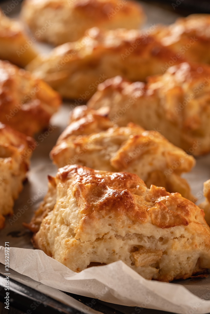 Tasty, fragrant and tender scones with apples from the oven close-up Tasty, fragrant and tender scones with apples from the oven close-up