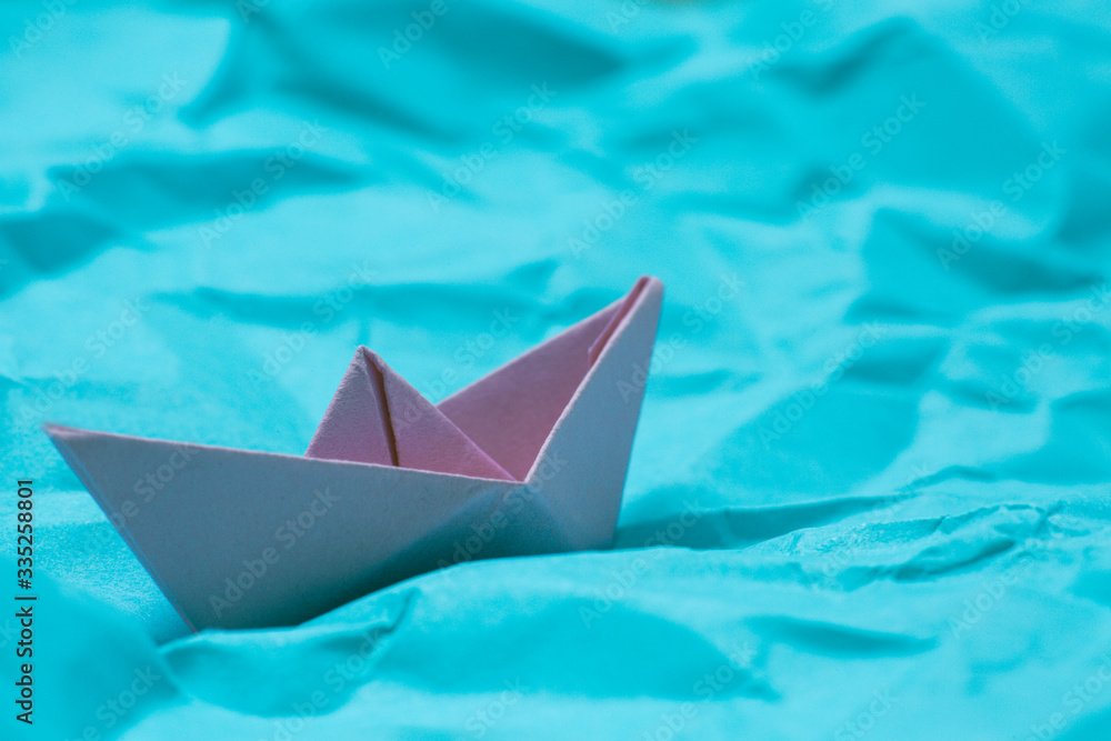 Origami ship in paper sea close up stock photo Origami ship in paper sea close up stock photo