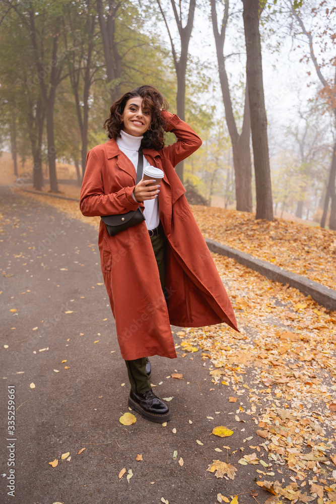 Excited lady with coffee in the park stock photo