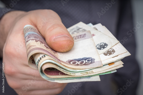 Close-up of russian banknotes in hand of man