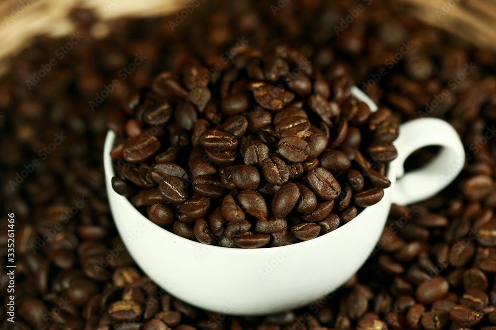 Coffee beans in a white cup , close up , top view