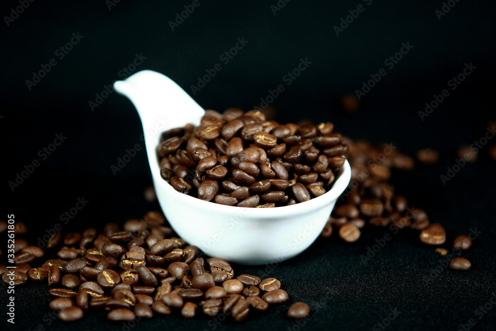 Fototapeta premium Coffee beans in a white cup , close up , top view