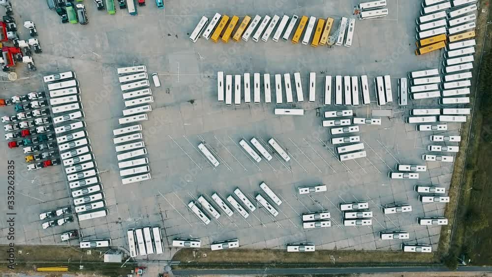 Ascending aerial top down shot if many trucks and construction vehicles on sales area Ascending aerial top down shot if many trucks and construction vehicles on sales area