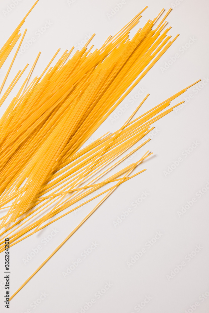 dry spaghetti pasta on white board background dry spaghetti pasta on white board background