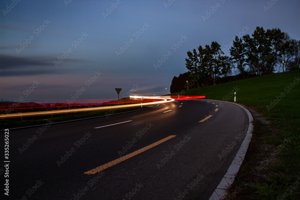 streaks of car lights during sun down in Switzerland streaks of car lights during sun down in Switzerland
