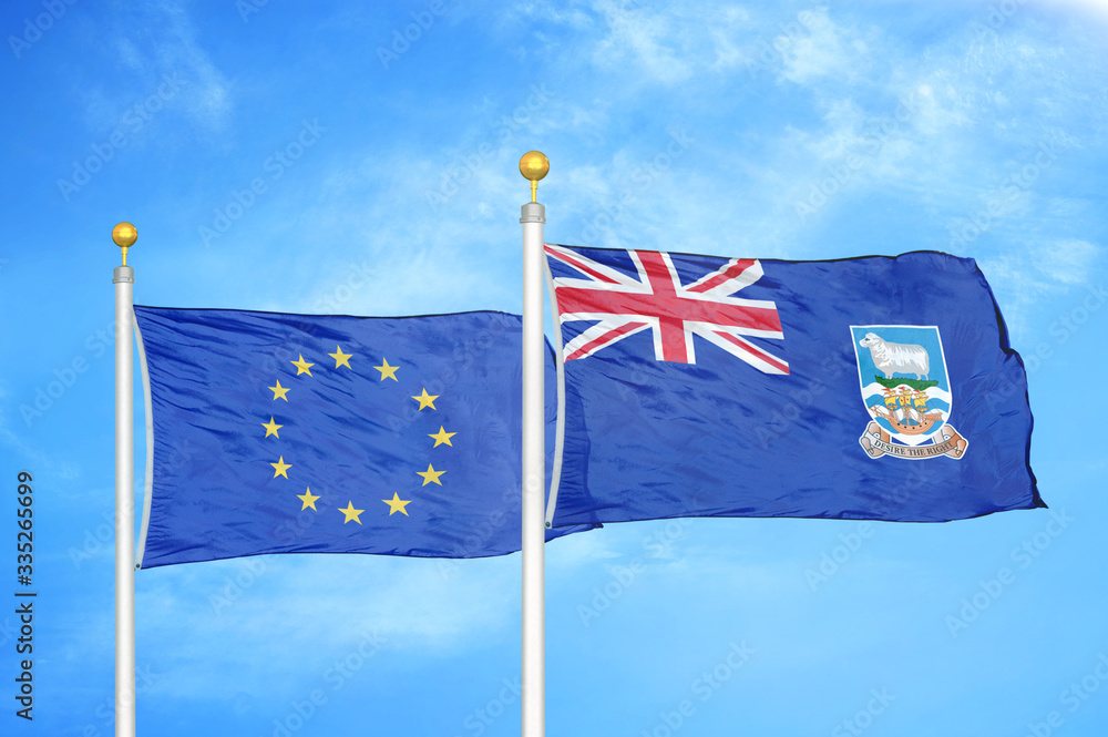 Fototapeta premium European Union and Falkland Islands two flags on flagpoles and blue cloudy sky