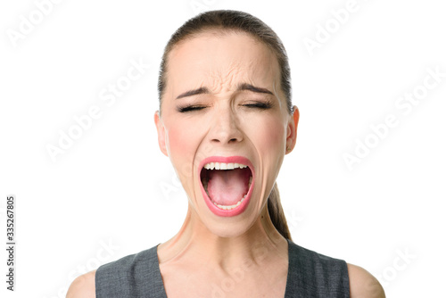 Valokuva Young woman screaming loudly. Isolated on white
