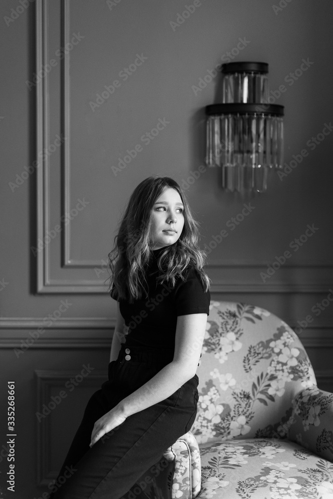 Girl in dark clothes on a modern interior background Girl in dark clothes on a modern interior background