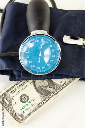 US dollar in a blood pressure monitor, currency treatment concept