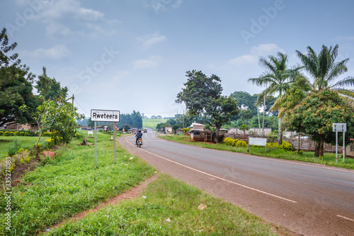 View of a road passing through a small town with house’s and vehicles, Rweteera, Fort Portal, Uganda, Africa
 photo