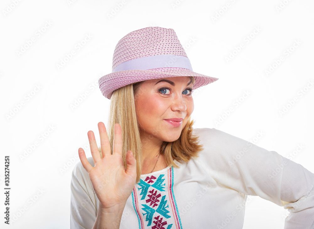 Isolated portrait of a smiling girl in a purple hat. Young beautiful girl shows five. Beautiful woman waves her hand. Isolated portrait of a smiling girl in a purple hat. Young beautiful girl shows five. Beautiful woman waves her hand.