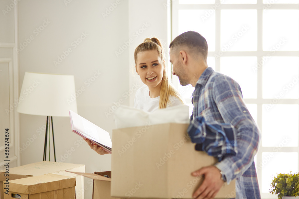 happy Young couple moving in new home happy Young couple moving in new home