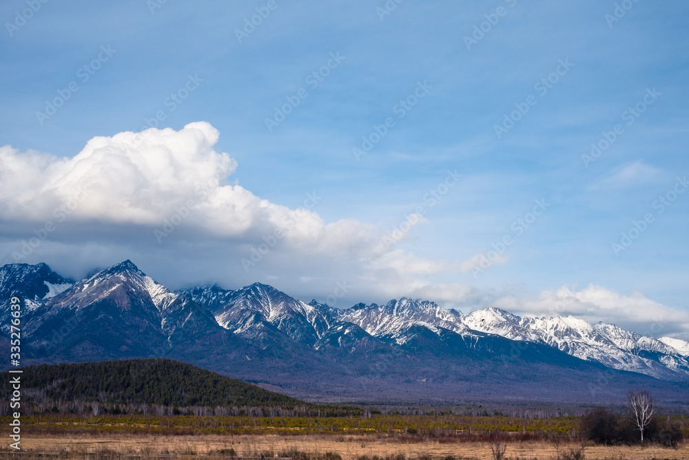 Landscape in the afternoon. Mountains with snowy peaks